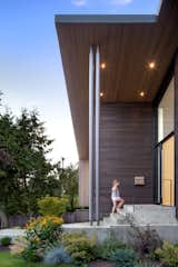 The exterior's many textures include stained western red cedar siding, a white oak veneer front door, and a concrete walkway.&nbsp;