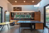 The open kitchen was converted from the original garage, and carries the wood pattern from the exterior inside with the accented ceiling.