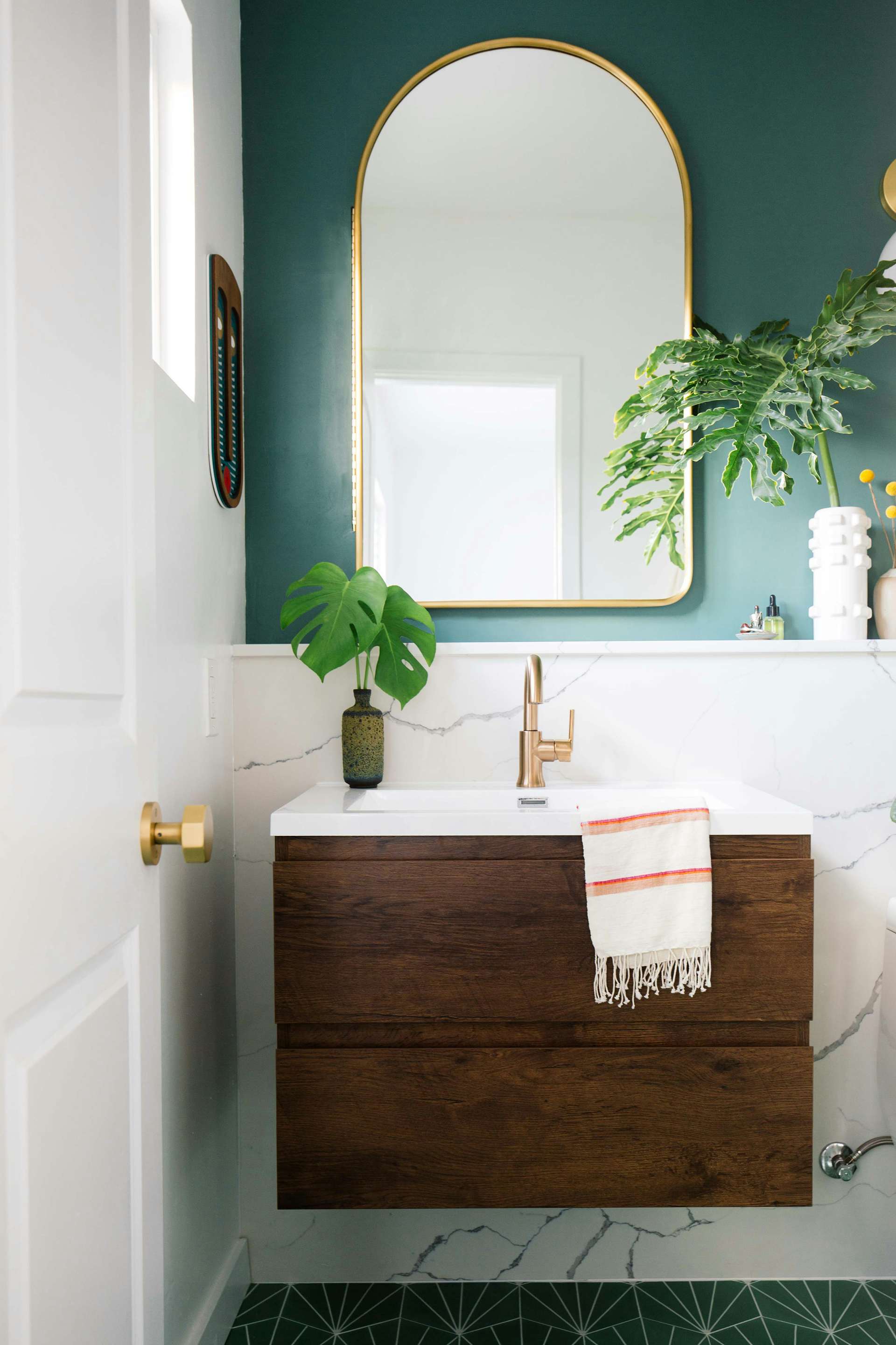 "This is the perfect space to go bold with wallpaper, tiles, and color," Dabito says of powder rooms—this bold green one is his design. "Make every inch count, and turn every corner into a statement." 