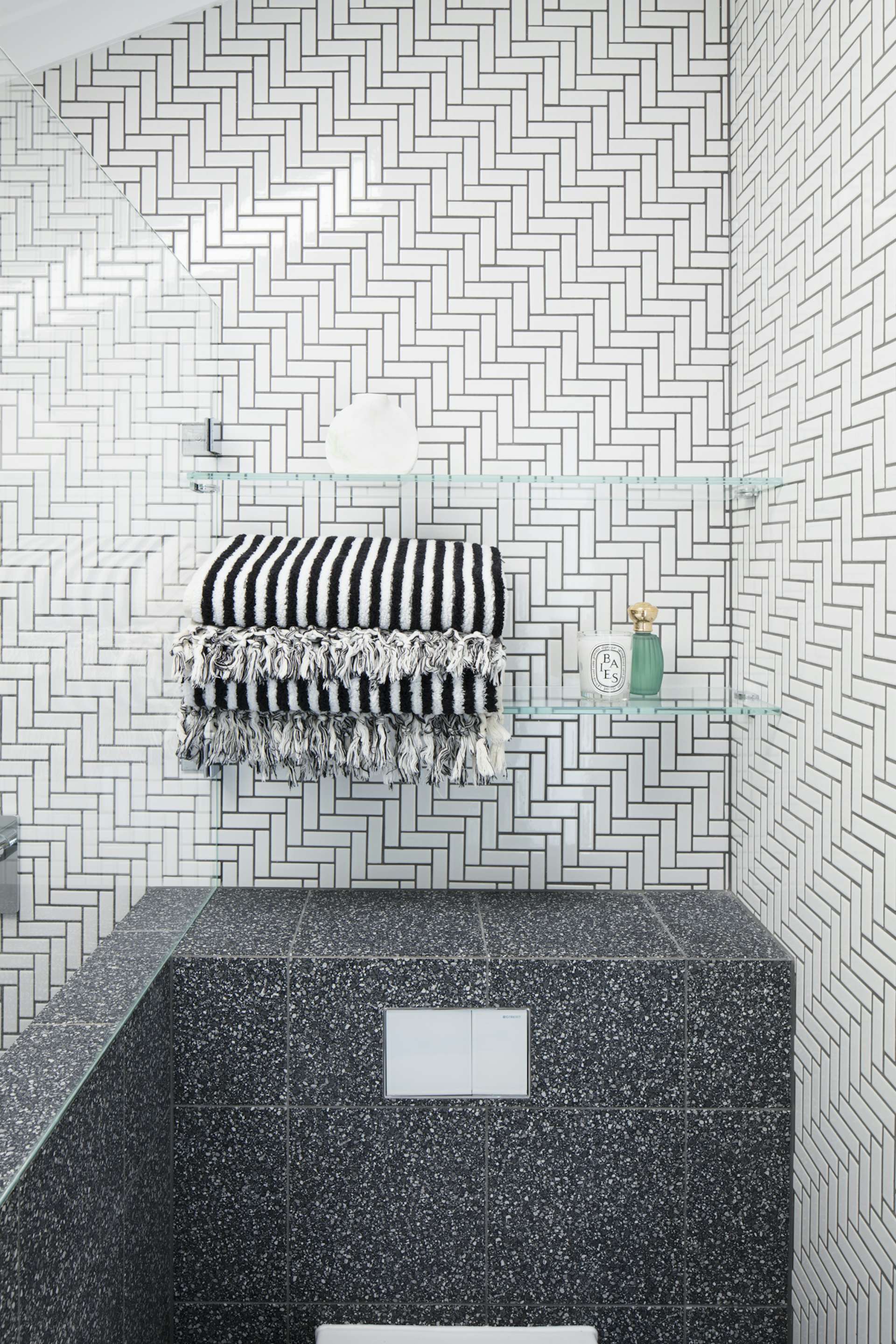 Bradley says that a powder room should tell a story. Aside from choosing bold fixtures and tiles, don't forget to add luxurious details, too. 