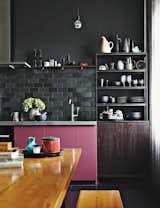 If you're itching for color in your kitchen, consider installing a striking black backsplash—it's sure to complement any shade that's near it. 