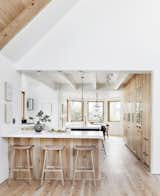Kitchen, Refrigerator, Light Hardwood Floor, Drop In Sink, Wood Cabinet, Pendant Lighting, and Ceiling Lighting Emily recommends creating "zones  Photo 3 of 5 in Designer Emily Henderson’s Simple Guide to Styling Your Home for Thanksgiving