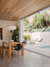 Courtyard House by Ras-a Studio dining room and patio with lap pool