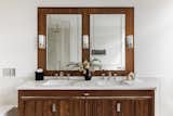 The bathroom's dark wood features mirror those in the kitchen, which is in keeping with Shea's goal to have a cohesive palette throughout.&nbsp;