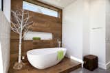 An Ethos bathtub contrasts woodwork by Porcelanosa in the master bathroom.