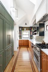 This kitchen's original footprint remained, but colorful cabinetry and vaulted ceilings made it a brighter, lighter space after its renovation.&nbsp;