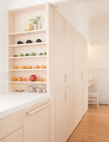 Read chose whitened birch plywood for the kitchen floors, which match the cabinetry. An office sits on the far end of the pantry. 