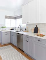 Macdonald opted for a traditional Shaker cabinet for the kitchen and laundry room, but painted the uppers in Benjamin Moore's "Chantilly Lace