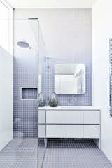 The bathrooms feature a clean, minimal blue-and-white palette, with a focus on durable, functional materials.