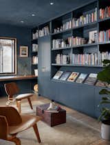 A new office sits at the front of the house, and its moody walls and bookshelves contrast the other rooms' mostly light and neutral palette.
