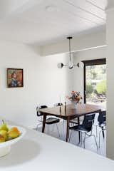 The owners opted to make the dining area smaller to accommodate a wider entryway on the opposite wall. They kept the tongue-in-groove ceiling throughout the home.
