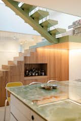 Their carpenter Proedl built a lot of the storage and furniture in the apartment, including these concealed cubbies beneath the stairs—with room for a dry bar, of course.