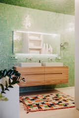 More than 6,000 pounds of green Moroccan tiles from Design Fliesen were used in their primary bathroom, which has two Falper faucets. There's a second full bathroom and two powder rooms.