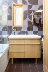 Cle tiles, a Duravit sink, and Vola fixtures were used in one of three bathrooms.