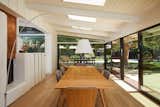 The dining area showcases the beams and glass that drew the owners to this home.
