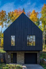 Exterior, House Building Type, Gable RoofLine, Wood Siding Material, Stone Siding Material, and Metal Roof Material Quartzite stone was used on the base of the structure, accompanied by charred Accoya wood.  Photo 14 of 263 in new home by Keri Berg from This Supersized Cabin in a Colorado Ski Town Brings Three Generations Together