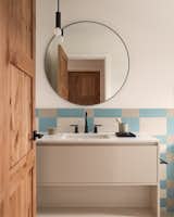 The four different bathrooms all have a different style. This one has a playful blue, gray, and white motif.