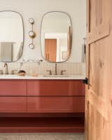 A terracotta vanity expands across the full length of the bathroom.