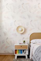 Statement wallpaper and an oversized sconce make this a dreamy second bedroom.
