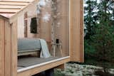 A full-length window ensures that the cabin is never short on natural light.  Photo 6 of 10 in These $31K Micro Cabins Are Light Enough to Be Dropped Into Place by a Helicopter