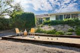 The couple kept the existing bocce court, and added throwback seating to match the midcentury mood.