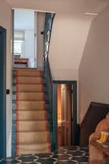 The existing stairs were painted in a dark yet neutral blue-gray, with a runner on top that has a coordinating pop of orange. While most of the home's historic details were removed by former owners, Leech's team tried to preserve what they could.