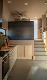 The stairs lead down to the kitchen, which gets some shade.