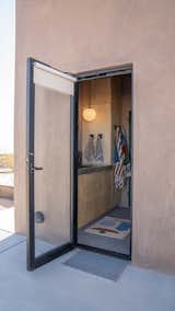 Bath Room and Drop In Sink The bathroom can be accessed from the side of the house, for those who are using the fresh water tubs.  Photo 10 of 15 in Budget Breakdown: She Turned a Joshua Tree Shack Into a Homestead for the Long Haul With $456K