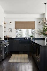 A Nickey Kehoe runner sits below a Waterworks faucet. "Bess and her husband requested no upper cabinets, floating shelves, or sconces,