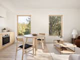 Dining Room, Chair, Table, and Light Hardwood Floor Type Five's planning process makes it possible for owners to choose exactly where windows go. In this ADU, two windows overlook surrounding trees.  Photos from Want to Design Your Own ADU? This Prefab Company Gives You the Tools