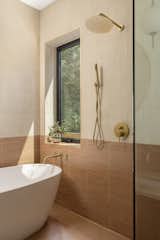 The large shower in the primary bathroom also has space for a tub, and if the window is open, the stream can be heard.
