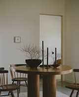 A Big Moon table by James Mitchell Studio is surrounded by Nakashima straight-back chairs.