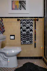Missoni towels coordinate with the motif in the bathroom, which has original tile work.