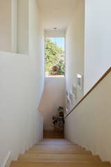 The ADU's main staircase is illuminated by a long window.