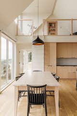 A loft makes use of the common area's double-height ceiling, which has a telescope for children to use.