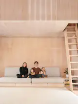 David, Edith, and their two children use the open living room to play. Concealed storage helps them keep everything minimalist.