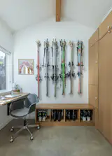 Ciera meticulously measured their skis and equipment so that everything would fit perfectly. The concrete flooring was the project's most expensive line item, at $19,519. The Mount Rainier print is by Caroline Clark, and the Eames rolling chair was purchased secondhand from Split-Level Modern.