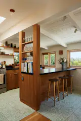 Zia terrazzo tile in Mesquite provides some color on the floor, while surrounding windows and a skylight make the space bright. Bosch appliances were selected for the kitchen, too.
