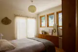A fresh coat of Benjamin Moore's White Dove was used in the bedroom and throughout the home. An existing dresser that was in the living space was moved into the bedroom, opposite Parachute bedding.
