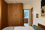 Custom cherry millwork was also used for closed storage in the bedroom, which is now connected to the bathroom.