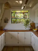 When the couple first moved into the property, they removed the upper cabinetry to make the kitchen feel more connected to the outdoors.