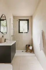 A walk-in shower in the bathroom has universal design in mind, and can be used to age-in-place as one option for owners.