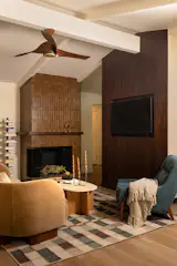 The renovation removed a wall between the living room and kitchen, and created more room with an addition. The remodeled fireplace cost $2,600.