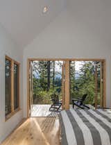 In the master bedroom, Douglas firs filter the light and mountain views for a more intimate experience.