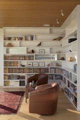 A smaller box just off the main living space is sized just right for a reading room. The clusters of small windows seamlessly morph into horizontal bookshelves.