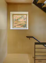 A punched-out square window acts as living art in the stairwell.