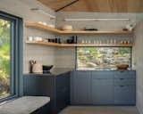 Kitchen A wet bar meets the needs of a dinner party or guest quarters. Windows punctuate the landward side to provide light, but smaller and with less frequency to create a sense of shelter.  Photo 11 of 17 in Boathouse by Prentiss + Balance + Wickline Architects