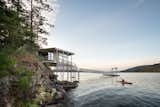 The Boathouse acts as a transition between land and sea, creating a literal connection through its pier and dock as well as a sensation of connectivity while inside the space.