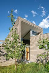 A dramatic angle marks the front door and entry from the auto-court.