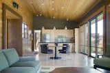 Kitchen, Refrigerator, Pendant Lighting, Wood Cabinet, Metal Backsplashe, Ceiling Lighting, and Concrete Floor  Photo 10 of 13 in Wolf Creek Cabin by Prentiss + Balance + Wickline Architects